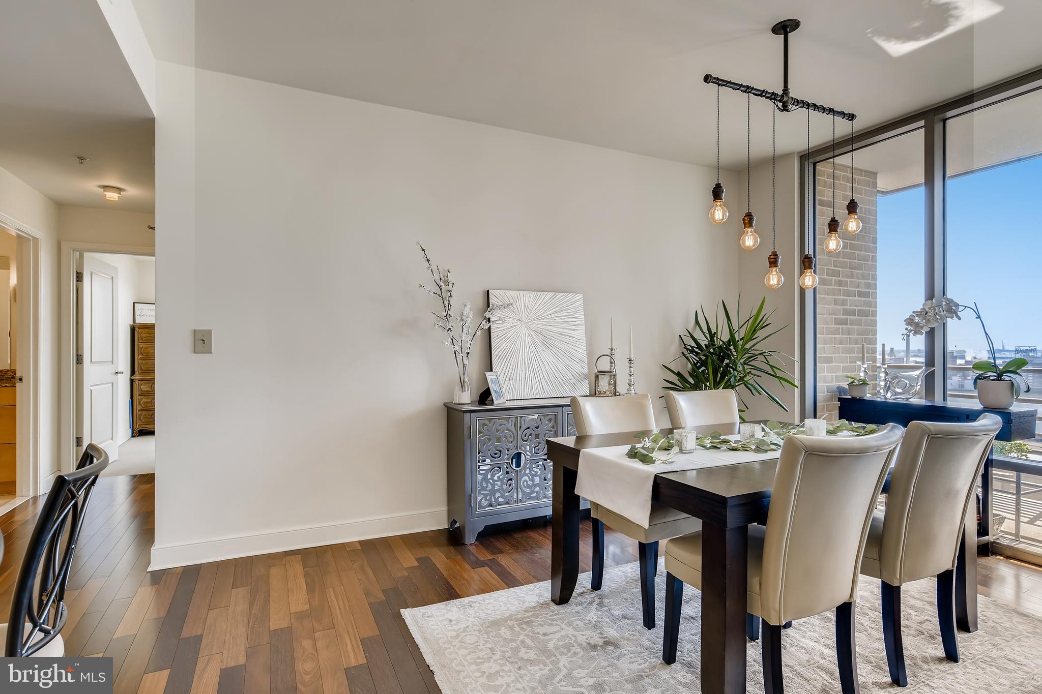 675 President Street, Unit 2105 Baltimore, MD 21202 - Photo 12 of 40 a view of a dining room with furniture and wooden floor