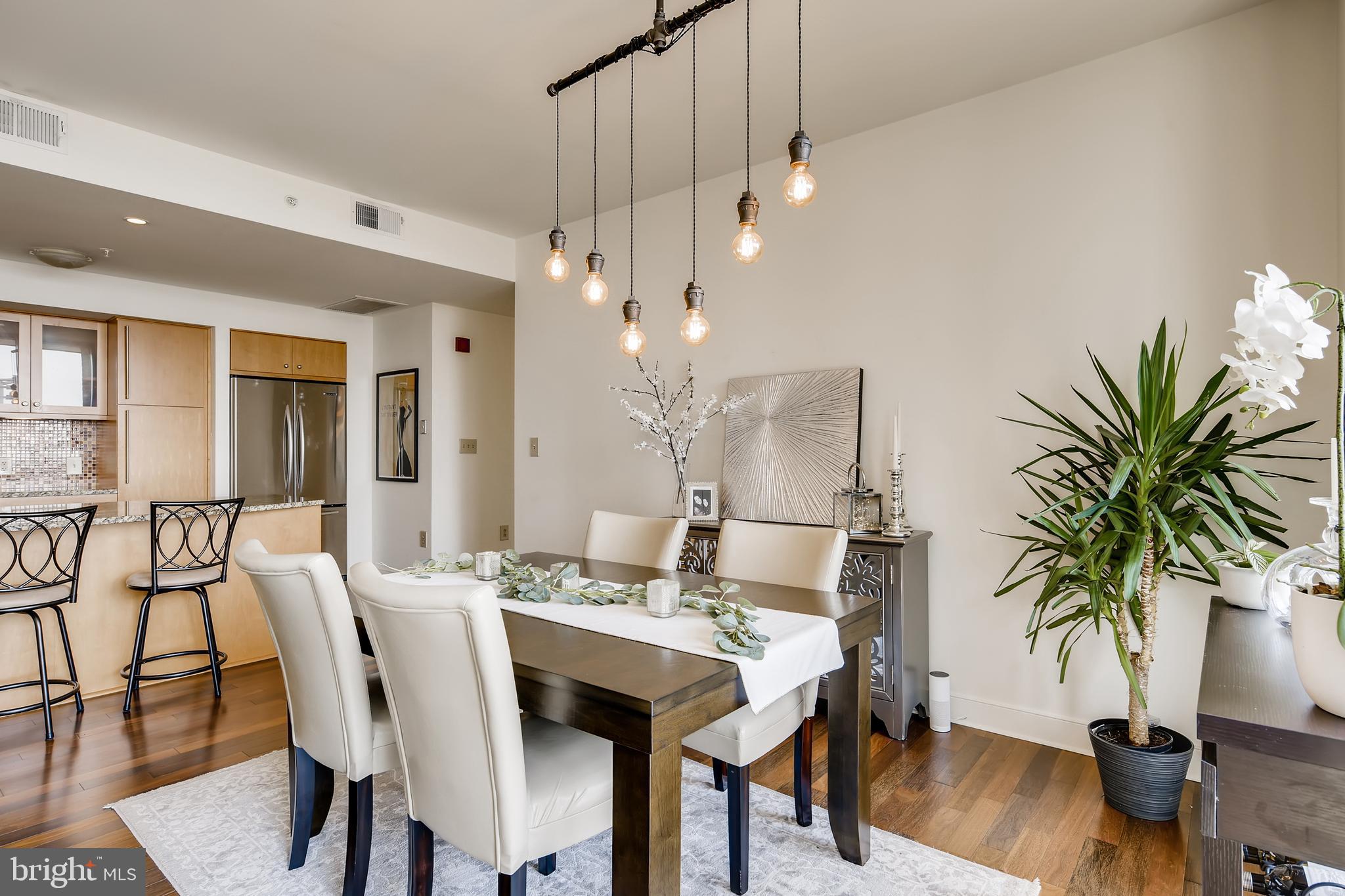 675 President Street, Unit 2105 Baltimore, MD 21202 - Photo 13 of 40 a view of a dining room with furniture and wooden floor