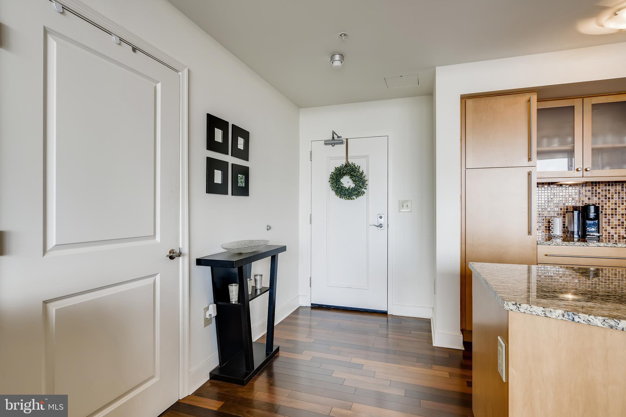 675 President Street, Unit 2105 Baltimore, MD 21202 - Photo 14 of 40 a view of a hallway with wooden floor and dining room