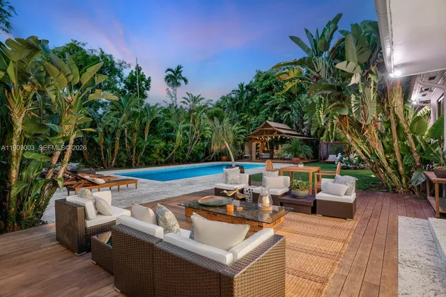 a view of a patio with couches and a potted plant on a table