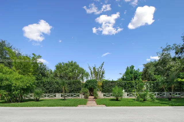a living room with furniture a large window and wooden floor