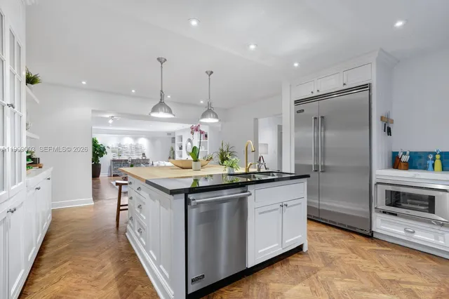 a kitchen with kitchen island granite countertop a stove and a sink