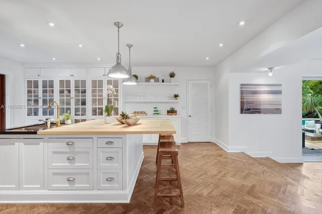 a kitchen with a stove a sink and a refrigerator