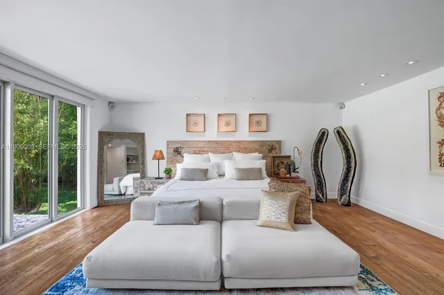 a bedroom with furniture and a window