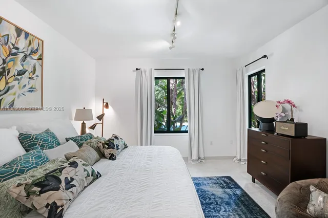 a view of a patio with table and chairs potted plants with wooden floor