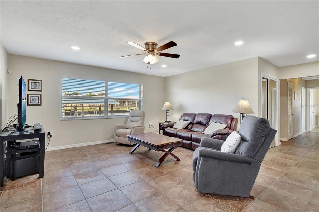 250 Bangsberg Road Southeast Port Charlotte, FL 33952 - Photo 8 of 59 a living room with furniture and a ceiling fan