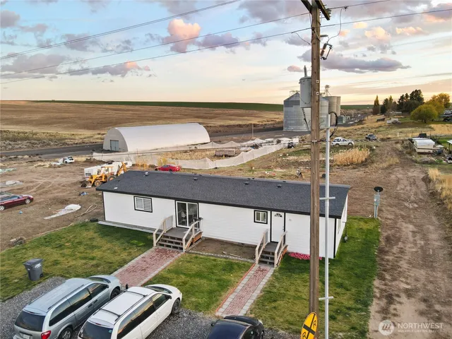 a view of a terrace with lawn chairs