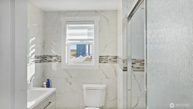 a bathroom with a toilet sink and vanity