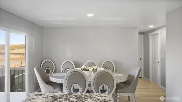 a view of a dining room with furniture and a window