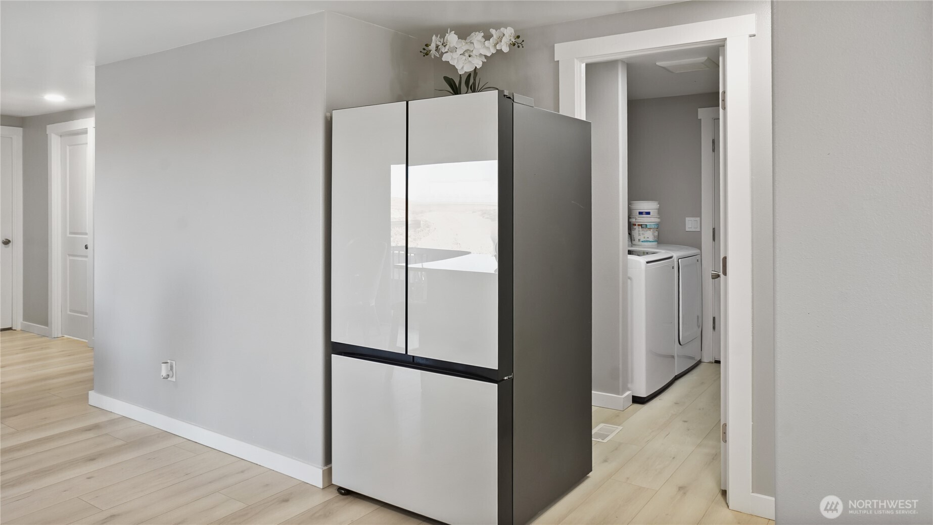 35 Hampton Road Othello, WA 99344 - Photo 26 of 33 a view of a kitchen with a refrigerator and wooden floor