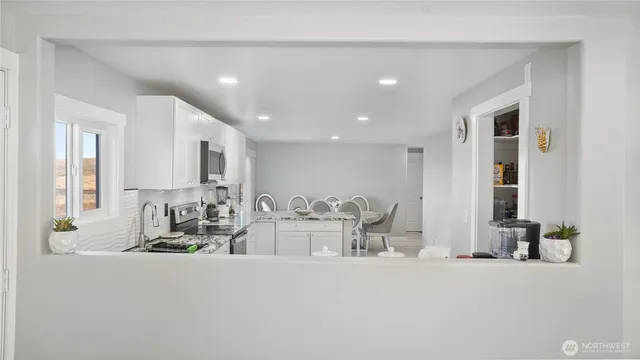 a kitchen with a sink cabinets and window