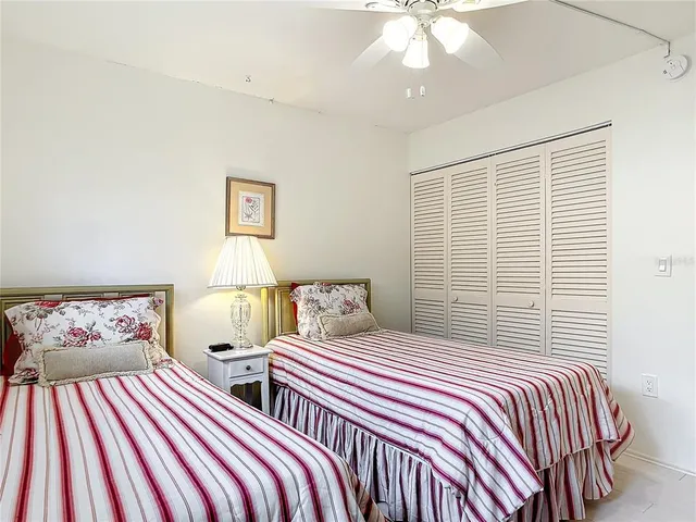 a bedroom with two beds and a chandelier