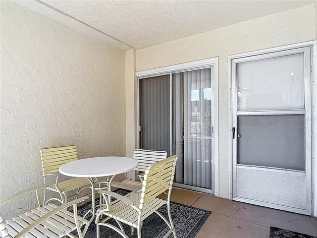 a view of a room with a table and chairs