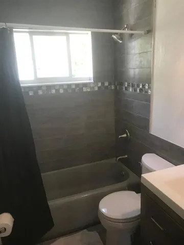 a white toilet sitting next to a bathroom sink