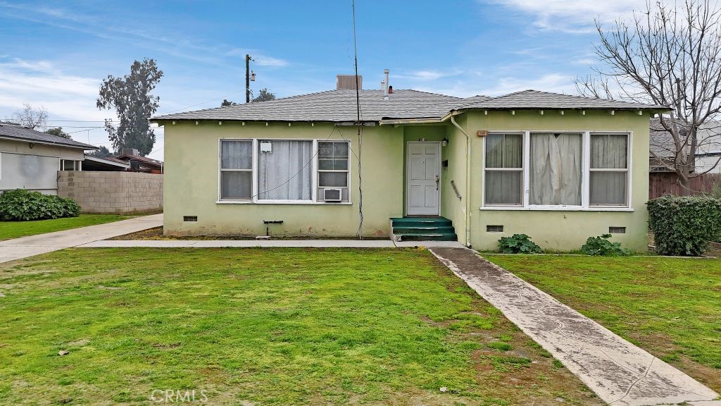 1601 5th Street Wasco, CA 93280 - Photo 1 of 1 a front view of a house with a yard