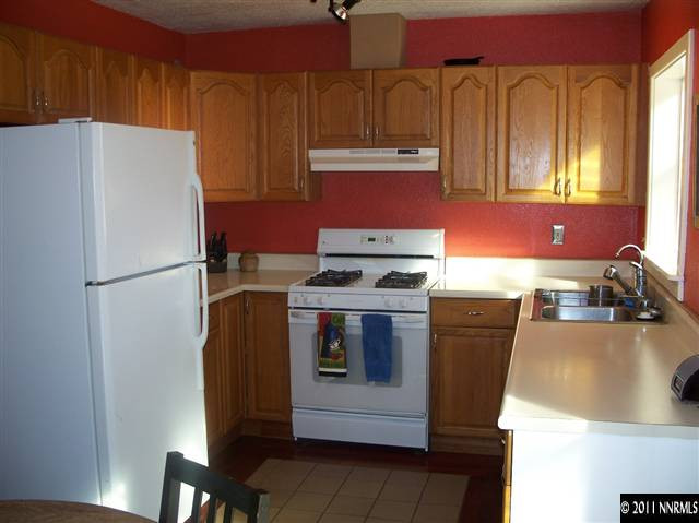 1960 Lassen Drive Reno, NV 89503 - Photo 3 of 13 a kitchen with a refrigerator and a stove top oven