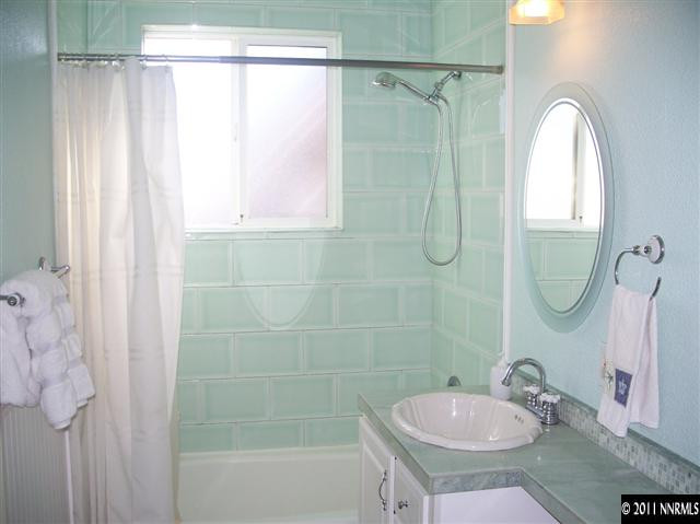 1960 Lassen Drive Reno, NV 89503 - Photo 8 of 13 a bathroom with a sink a mirror a window and a shower