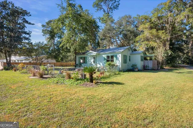 a view of a house with a yard and sitting area