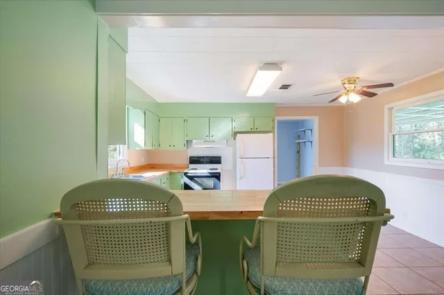 a kitchen with a refrigerator and a sink