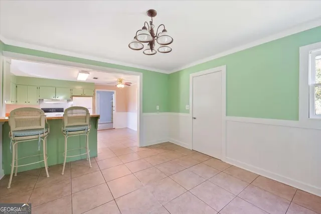 a bathroom with a toilet a sink a vanity a window and mirror