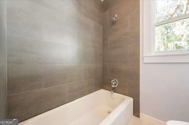 a bathroom with a sink toilet and mirror