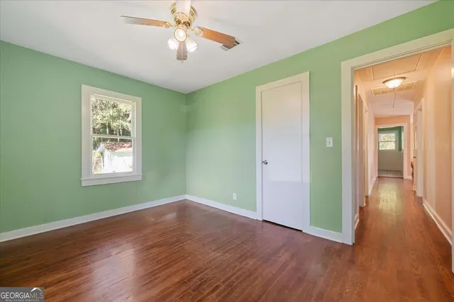 a view of a backyard with table and chairs under an umbrella