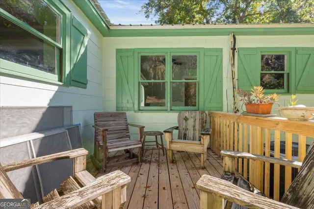 a white house that has a tree in front of it