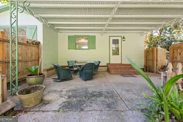 an empty room with wooden floor chandelier fan and windows