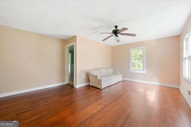 a living room with furniture and a ceiling fan