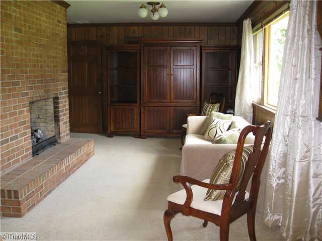 3734 Fieldview Road Pleasant Garden, NC 27313 - Photo 12 of 16 Den/Family/Great Room. Comfortable den has a gas log fireplace, new carpet, crown molding, and built-ins.
