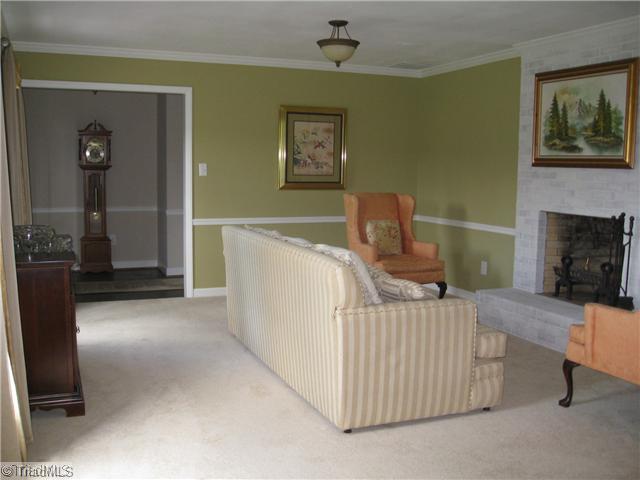 3734 Fieldview Road Pleasant Garden, NC 27313 - Photo 15 of 16 Living Room. View from the dining room, looking towards the foyer. Nice and open, terrific floor plan for entertaining family and friends. There is also a fireplace in the den and basement.