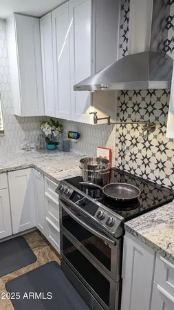 a kitchen with stainless steel appliances kitchen island granite countertop a sink and cabinets