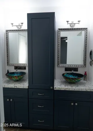 a bathroom with a mirror and a sink