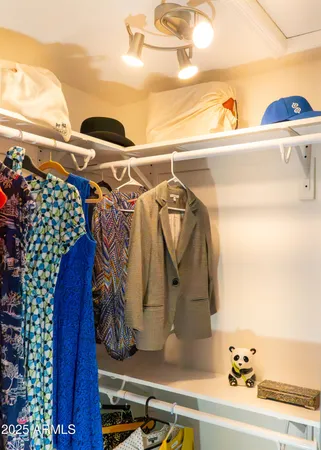 a bedroom with a bed computer sitting on desk and a chair