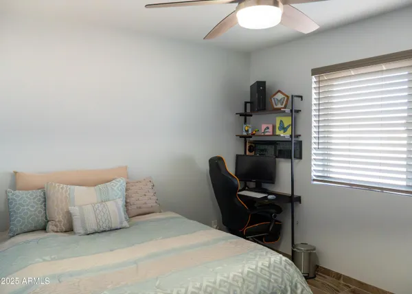 a view of a bedroom with baby crib and dresser