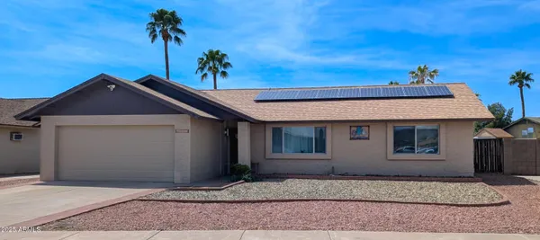 a kitchen with stainless steel appliances a refrigerator a stove a sink dishwasher with a dining table and chairs