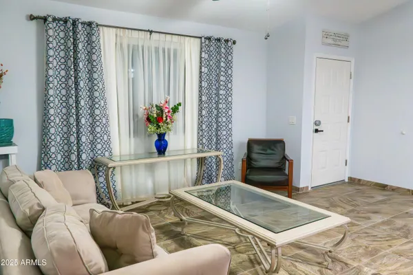 a kitchen with stainless steel appliances granite countertop a table chairs refrigerator and sink