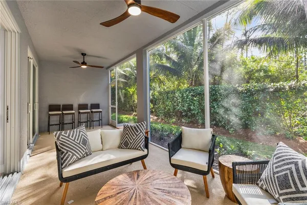 a balcony with furniture and a floor to ceiling window