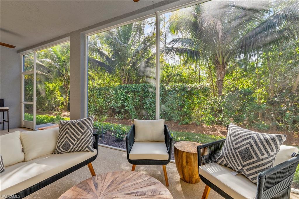 2640 Seychelles Circle, Unit 2802 Naples, FL 34112 - Photo 21 of 32 a living room with furniture and a large window