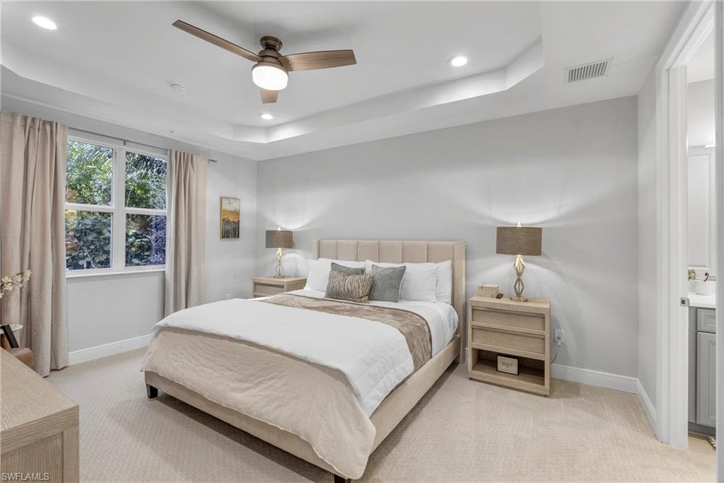 2640 Seychelles Circle, Unit 2802 Naples, FL 34112 - Photo 22 of 32 a bedroom with a bed and a window