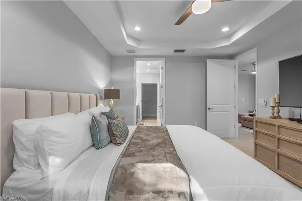 a bed room with a bed and a large mirror