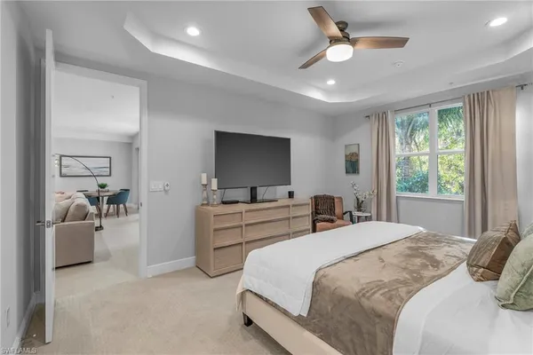 a bedroom with a bed and a large window