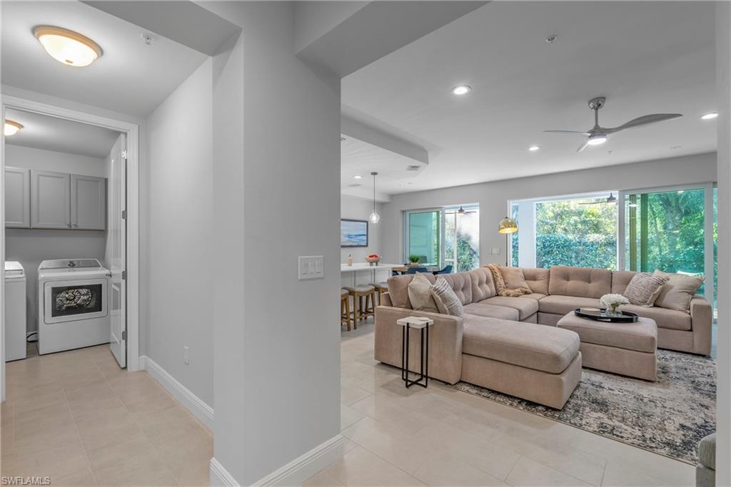 2640 Seychelles Circle, Unit 2802 Naples, FL 34112 - Photo 29 of 32 a living room with furniture and a large window