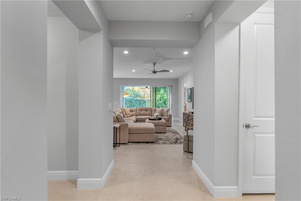 2640 Seychelles Circle, Unit 2802 Naples, FL 34112 - Photo 6 of 32 a living room with furniture and a large window