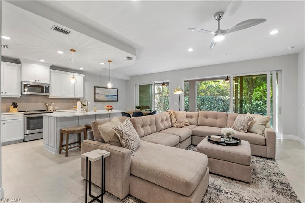 2640 Seychelles Circle, Unit 2802 Naples, FL 34112 - Photo 7 of 32 a living room with stainless steel appliances kitchen island furniture and a large window