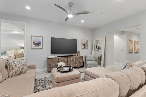 a living room with furniture and a flat screen tv