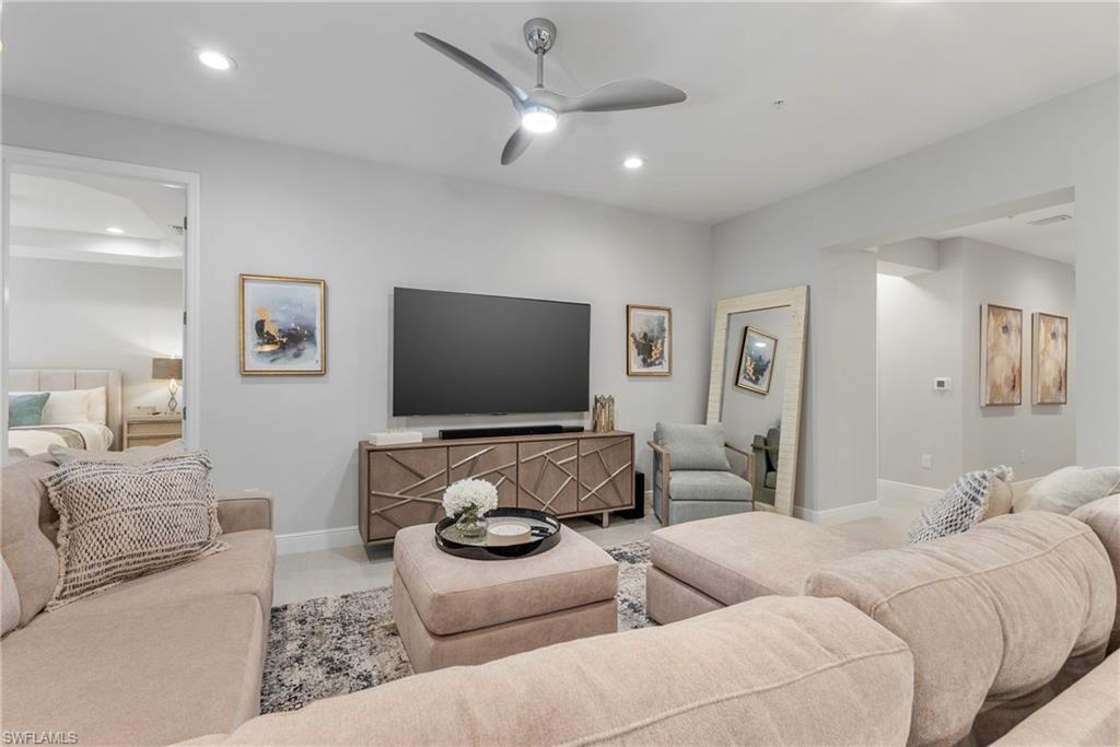 2640 Seychelles Circle, Unit 2802 Naples, FL 34112 - Photo 8 of 32 a living room with furniture and a flat screen tv