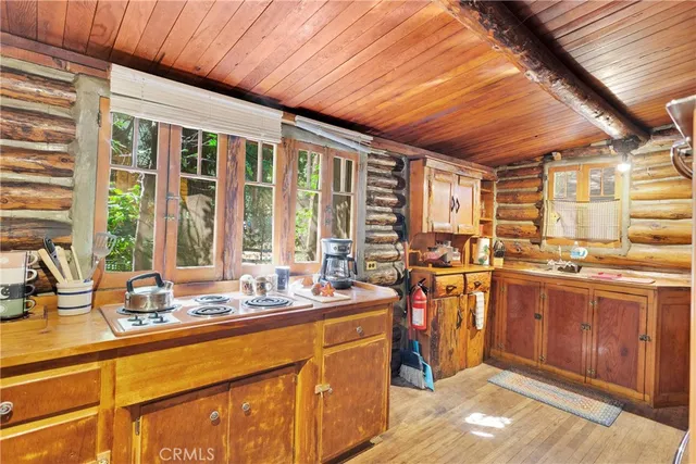 a view of a kitchen with kitchen island granite countertop a large window