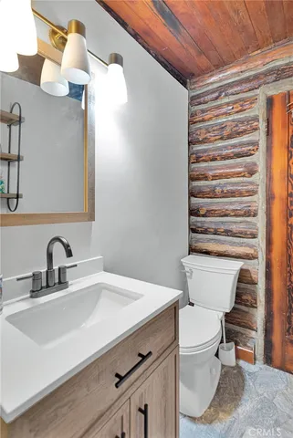 a bathroom with a sink a toilet and shower curtain