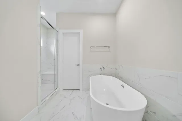 a bathroom with a bathtub and shower